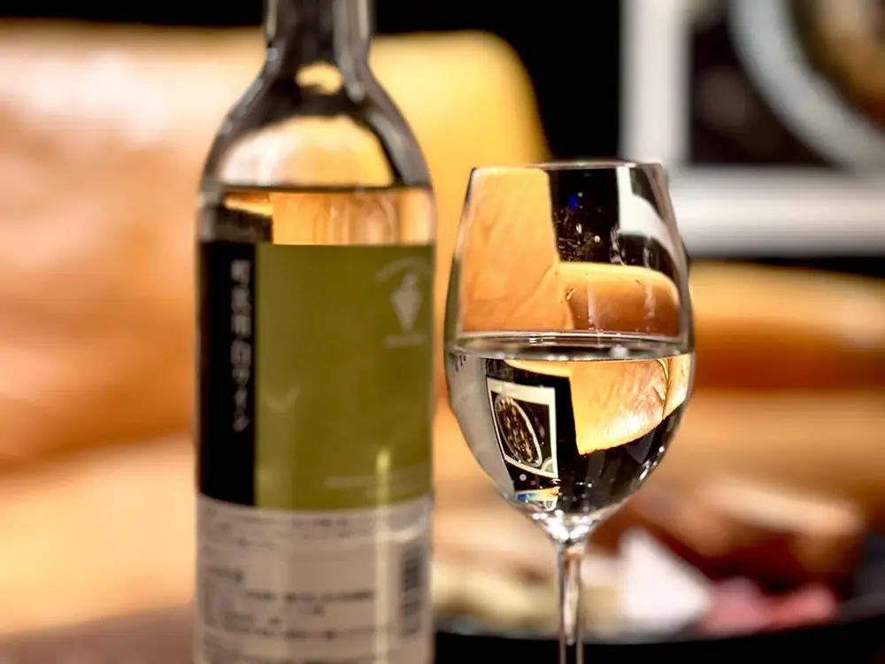 グラスに注がれた町民用白ワインと瓶の画像